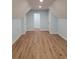 Finished attic bonus room with light blue walls, light wood floors, and doors for plenty of storage at 214 Carolina Dr., Loris, SC 29569