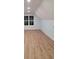 Finished attic bonus room with light blue walls, light wood floors and a window for lots of natural light at 214 Carolina Dr., Loris, SC 29569