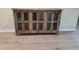 Rustic wooden cabinet with glass doors and paneled detailing for a touch of classic style at 214 Carolina Dr., Loris, SC 29569
