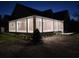 Exterior elevation of the home featuring a large covered porch area with multiple windows and white columns at 214 Carolina Dr., Loris, SC 29569