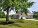 A picturesque view of the home with a lush lawn, mature trees, and a well-maintained exterior at 214 Carolina Dr., Loris, SC 29569