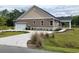 A well-maintained home with a curved driveway and lush landscaping, offering great curb appeal at 214 Carolina Dr., Loris, SC 29569