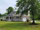 Beautifully landscaped home with a well-manicured lawn and an attached garage, showcasing great curb appeal at 214 Carolina Dr., Loris, SC 29569