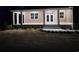 Inviting front exterior of a home with a covered porch, white columns, and well-manicured landscaping at 214 Carolina Dr., Loris, SC 29569