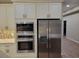 Modern kitchen with stainless steel appliances, built-in microwave and oven, and custom cabinetry at 214 Carolina Dr., Loris, SC 29569