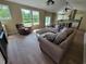 Open-concept living space with a cozy seating arrangement, ample natural light, and a kitchen in the background at 214 Carolina Dr., Loris, SC 29569