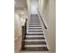 Staircase with wooden treads and risers, complemented by dark wooden balusters and a white handrail at 214 Carolina Dr., Loris, SC 29569
