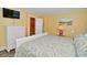 Well-lit bedroom with a mounted TV, modern decor, and easy access to the bathroom at 219 27Th Ave. N, North Myrtle Beach, SC 29582