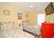 Sunny bedroom featuring two twin beds, soft floral linens, and colorful decor at 219 27Th Ave. N, North Myrtle Beach, SC 29582