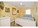 Comfortable bedroom with queen bed, light colored walls, light fixture and tropical themed wall decorations at 219 27Th Ave. N, North Myrtle Beach, SC 29582