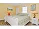 Cozy bedroom featuring a comfortable queen bed, warm yellow walls, and modern decor at 219 27Th Ave. N, North Myrtle Beach, SC 29582