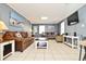 Inviting living room with tile floors, two plush sofas, a coffee table, and a mounted TV at 219 27Th Ave. N, North Myrtle Beach, SC 29582