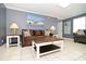 Comfortable living room featuring a sofa, coffee table and tile flooring at 219 27Th Ave. N, North Myrtle Beach, SC 29582