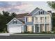 Charming two-story home showcasing a welcoming porch, well-manicured landscaping, and a two-car garage at 220 River Edge Dr., Myrtle Beach, SC 29588