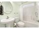 Bathroom featuring a pedestal sink, toilet, shower and tub combination, with a window to provide natural light at 220 Waterfall Circle, Little River, SC 29566