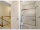Bathroom including a shower with glass doors, tile flooring, toilet, and stairway at 220 Waterfall Circle, Little River, SC 29566