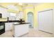 Spacious kitchen features white cabinets, black granite countertops, an island, and tile floors at 220 Waterfall Circle, Little River, SC 29566