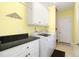 Bright laundry room features a modern washer and dryer with white cabinets and dark countertop at 220 Waterfall Circle, Little River, SC 29566