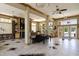 Lounge area with a fireplace, ample seating, and French doors leading to a pool at 220 Waterfall Circle, Little River, SC 29566