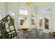Cozy sunroom featuring tile floors, large windows, and casual hanging chairs at 220 Waterfall Circle, Little River, SC 29566