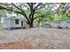 Backyard featuring mature shade trees and detached storage sheds, along with a gravel surface at 2206 Beck St., Georgetown, SC 29440