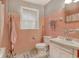 Vintage-style bathroom with classic pink tile, white fixtures, and ample natural light at 2206 Beck St., Georgetown, SC 29440