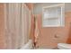 Bathroom featuring a bathtub with shower, pink tiling, and vintage towel rack at 2206 Beck St., Georgetown, SC 29440