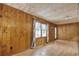 The spacious living room features wood paneling, a large window, and hardwood floors at 2206 Beck St., Georgetown, SC 29440