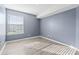 Empty bedroom featuring wood-look floors and a large window at 2258 Essex Dr. # G, Surfside Beach, SC 29575