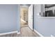 A bright entrance features gray wood flooring, a light blue painted wall, and an open doorway to the hallway at 2258 Essex Dr. # G, Surfside Beach, SC 29575