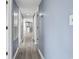 Bright hallway with luxury vinyl flooring, light blue paint and white doors at 2258 Essex Dr. # G, Surfside Beach, SC 29575