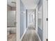 Hallway view showing the bathroom, hardwood floors, and light blue walls at 2258 Essex Dr. # G, Surfside Beach, SC 29575
