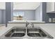 A functional kitchen featuring a stainless steel sink and fixtures, white countertops, and a spacious window at 2258 Essex Dr. # G, Surfside Beach, SC 29575