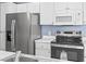 Updated kitchen boasts stainless steel appliances, white cabinets and counters, plus modern microwave at 2258 Essex Dr. # G, Surfside Beach, SC 29575