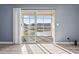 Living room with open slider to view, luxury vinyl floors and neutral blue wall at 2258 Essex Dr. # G, Surfside Beach, SC 29575