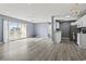 An open-concept living space featuring wood flooring, light blue walls, a fan, and an open kitchen at 2258 Essex Dr. # G, Surfside Beach, SC 29575