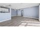 An open-concept living space featuring wood flooring, light blue walls, and good natural lighting at 2258 Essex Dr. # G, Surfside Beach, SC 29575