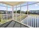 Relaxing screened-in porch overlooking tranquil pond and neighboring buildings and parking lot at 2258 Essex Dr. # G, Surfside Beach, SC 29575