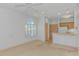 Bright living room features large arched window, ceiling fan, and flows into a compact kitchen with light wood cabinets at 2312 Sweetwater Blvd. # 2312, Murrells Inlet, SC 29576