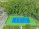 Aerial view of a meticulously maintained community tennis court surrounded by lush greenery and parking at 2312 Sweetwater Blvd. # 2312, Murrells Inlet, SC 29576