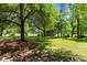 Lush green space featuring mature trees and a serene pond in the background at 234 Westleton Dr. # 21-C, Myrtle Beach, SC 29572