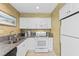 Well-lit kitchen with white cabinetry, granite counters, and essential appliances at 234 Westleton Dr. # 21-C, Myrtle Beach, SC 29572