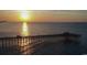 Sunset view of a pier stretching into the ocean, reflecting the warm light and offering scenic views at 234 Westleton Dr. # 21-C, Myrtle Beach, SC 29572