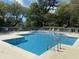 Inviting swimming pool with surrounding lounge chairs and lush greenery at 234 Westleton Dr. # 21-C, Myrtle Beach, SC 29572