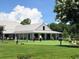 People enjoying a putting green near a clubhouse with a metal roof, offering a recreational amenity at 234 Westleton Dr. # 21-C, Myrtle Beach, SC 29572