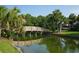 Scenic water view featuring a wooden bridge, palm trees, and lush vegetation at 234 Westleton Dr. # 21-C, Myrtle Beach, SC 29572