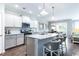 Stylish kitchen featuring a center island with chairs, modern appliances, and pendant lighting at 2425 Watershed Way, Longs, SC 29568
