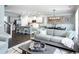 Open concept living room featuring hardwood floors, decor, and modern lighting at 2425 Watershed Way, Longs, SC 29568