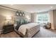 Spacious main bedroom features plush carpeting, decorative mirrors, and stylish furnishings at 2425 Watershed Way, Longs, SC 29568