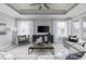 Bright living room with modern decor, tray ceiling, ample natural light, and comfortable seating at 2517 Watershed Way, Longs, SC 29568
